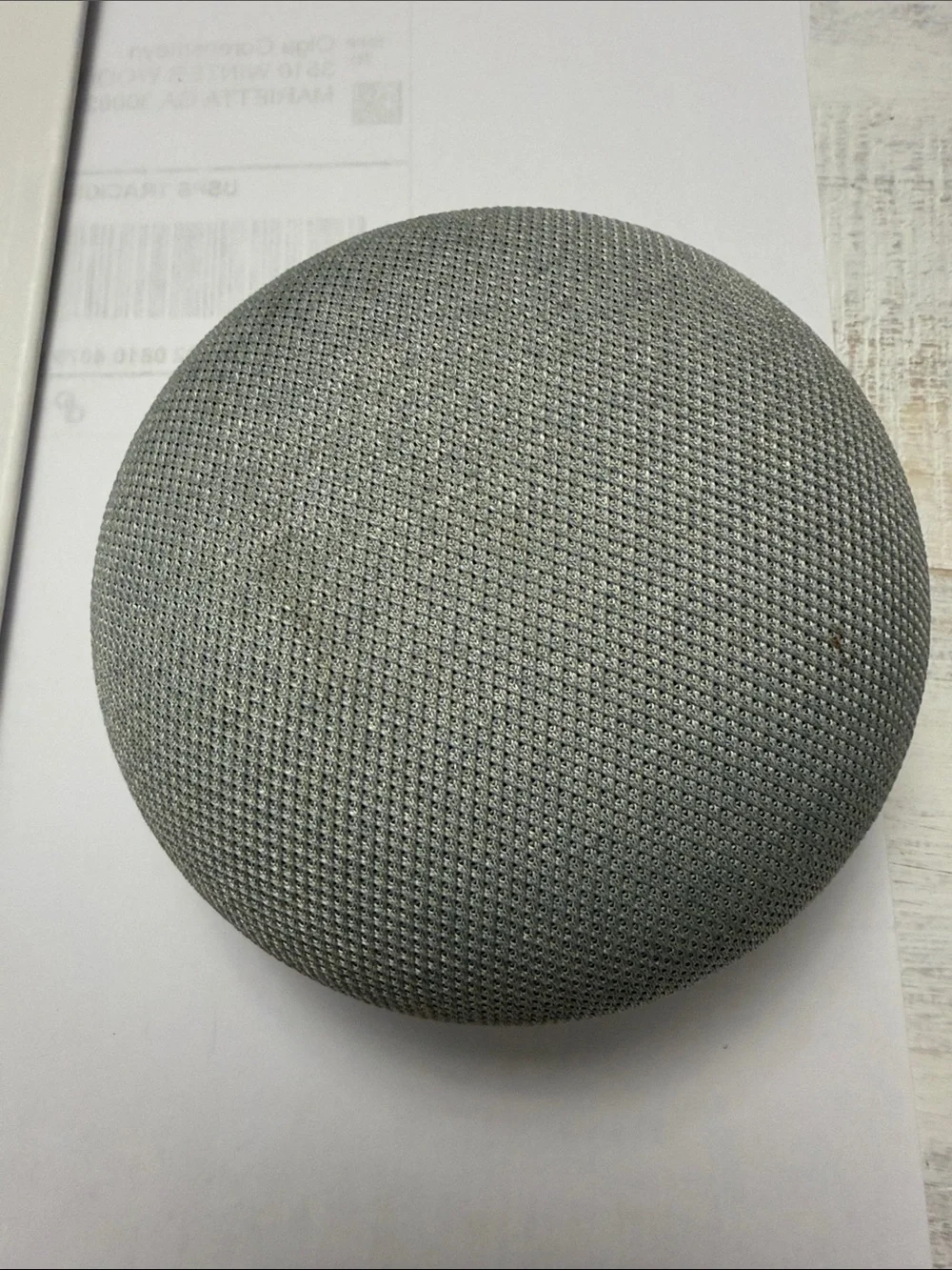 google smart speaker with white body and orange base